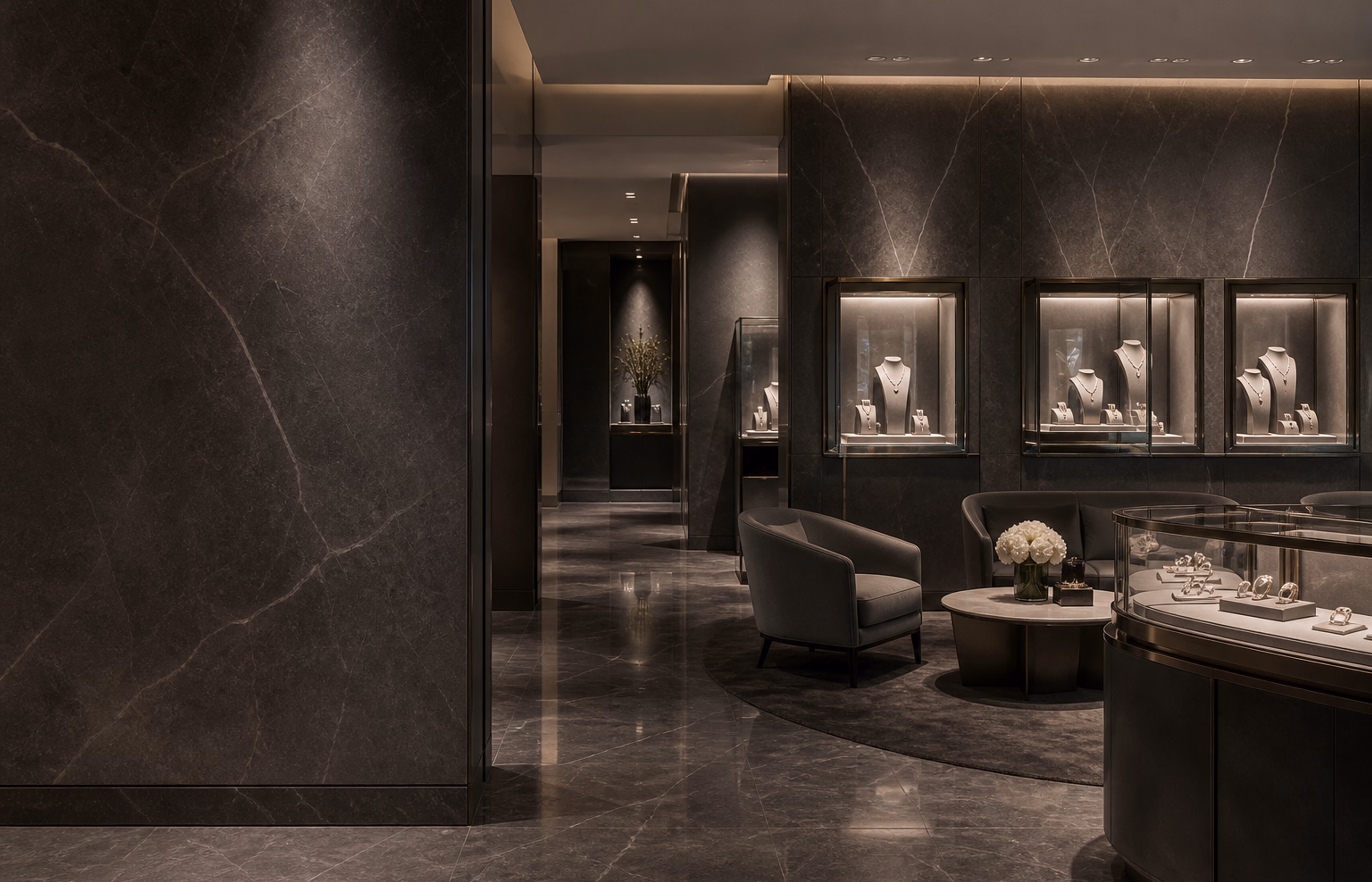 Private high-jewelry salon atmosphere with architectural stone and discreet seating.
